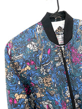 Load image into Gallery viewer, Vintage bomber jacket with jewel tone blue, pink and white floral print a front zipper and black trim on collar, sleeves and waist.