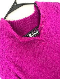 vintage sweater in a vibrant magenta color with top buttons.